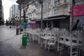 Closed sidewalk cafe during lockdown. Chairs placed on top of the tables before the opening of the restaurant Royalty Free Stock Photo