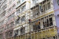 Workers dismantle the bamboo scaffolding outside the building