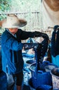 Process of making indigo dye fabric, woman dying fabric with ind