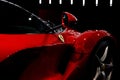 Maranello, Italy - April 01, 2023: Side view of a red Ferrari sports car with a streamlined body and mirror. Royalty Free Stock Photo