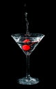 Maraschino cherry dropped in cocktail glass Royalty Free Stock Photo