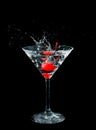 Maraschino cherry dropped in cocktail glass Royalty Free Stock Photo