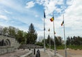 Marasesti, Romania-May 2, 2021: The three masts with the flags of Romania and the European Union, on the blue background of the