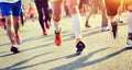 Marathon athletes legs running on city road