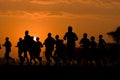 Marathon black silhouettes of runners on the sunrise, neural network generated image Royalty Free Stock Photo