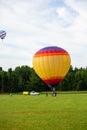 Marathon County, Wisconsin, USA, July 10, 2021: Taste N Glow Balloon Fest. Hot air balloon landing on a farmers field in central