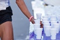 Marathon racer catching cup of water