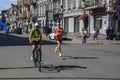 Marathon runner leader run on the street and the lead bike takes him through the streets