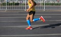 Marathon runner running on city road