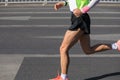 Marathon runner running on city road