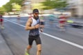 Marathon runner in motion on the street. Urban sport