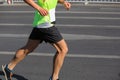 Marathon runner running on city road