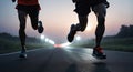 Marathon runner running on city road at sunset. Group of people running on road at night.