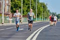 Marathon runners on city road Royalty Free Stock Photo