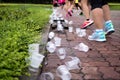 Marathon runners feet and emptry water cups on refreshment point