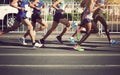 Marathon runners running on city road