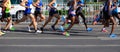 Marathon runners running on city road