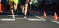 Marathon runners running on city road,detail on legs Royalty Free Stock Photo
