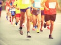 Marathon runners running on city road Royalty Free Stock Photo