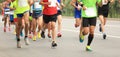 Marathon runners running on city road Royalty Free Stock Photo