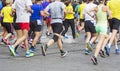 Marathon runners running race people feet on city