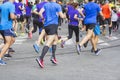 Marathon runners running race people feet on city