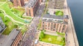 Marathon running race, aerial view of start and finish line with many runners from above, road racing, sport competition