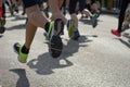 Marathon running race, many runners feet on road racing, sport competition