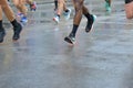 Marathon running race, many runners feet on road racing, sport competition, fitness and healthy lifestyle