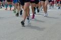 Marathon running race, many runners feet on road, sport, fitness and healthy lifestyle