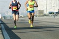 Marathon running race, people feet on city road. Group of young runners a few meters from the arrival of difficult marathon