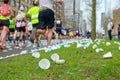 Marathon running race, runners feet and plastic water cups on road near refreshment point, sport, fitness and healthy lifestyle