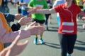 Marathon running race, support runners on road, child`s hand highfive, sport concept Royalty Free Stock Photo