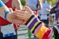 Marathon running race, supporting runners on road, child hand giving highfive, sport event Royalty Free Stock Photo