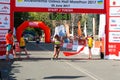 Marathon winner woman at finish. Happy marathon runner finish line Royalty Free Stock Photo