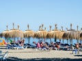 MARBELLA, COSTA DEL SOL, PROVENCE MALAGA/SPAIN - SEPTEMBER 16, 2016: Marbella beach with straw umbrellas. People relaxing