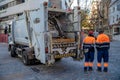 Marbella - January 16, 2020: collecting waste from a container by a special car in the streets of a big city