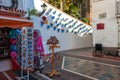 Small souvenir shop near the wall, decorated with blue flower pots