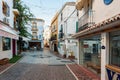 Traditional Spanish narrow street with souvenir shop and beautiful architecture in historical part of town