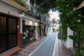 Traditional Spanish narrow street with souvenir shop and green plants in historical part of town