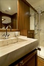 A marble bathroom, a mirror and a shower in a luxury yacht. Royalty Free Stock Photo