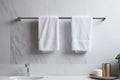 Marble bathroom wall and chrome hooks holding two white towels. Generative AI