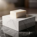 The marble block sits on a dark marble surface with lighter veins Royalty Free Stock Photo