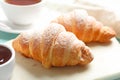 Marble board with tasty croissants and , closeup. French pastry