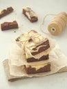 Marble brownies as a gift. Two-color chocolate cake cut into square pieces. Brownie cheesecake. Selective focus on the front. Vert Royalty Free Stock Photo