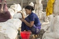 Burmese woman carving a Marble Buddha statue, Mandalay, Burma