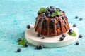 Marble bundt cake with chocolate icing and blueberries Royalty Free Stock Photo