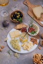 Marble Cheese board with delicous cheeses, nuts, honey and grapes Royalty Free Stock Photo