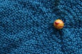 Marble colourful yellow and red close up from above on blue fabric background landscape format Royalty Free Stock Photo