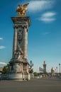 Marble column with golden statue adorning the Alexandre III bridge over the Seine River in Paris. Royalty Free Stock Photo